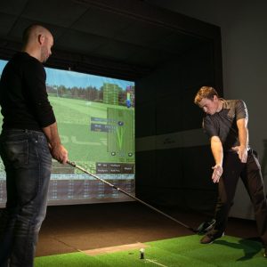 man teaching golf lesson