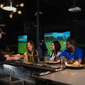 X-Golf bartender serving food